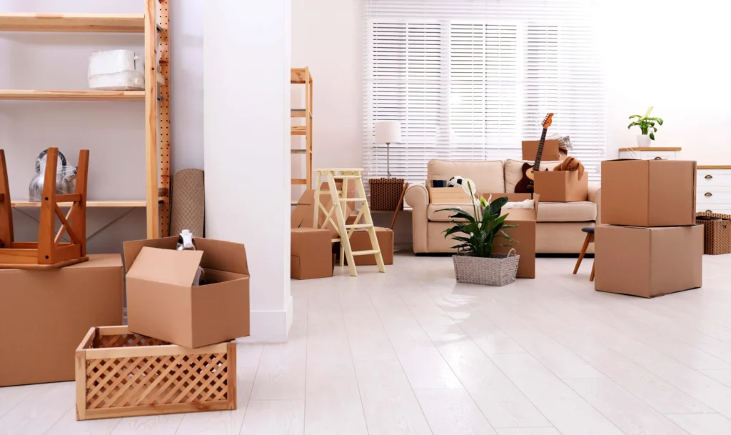 A living room filled with packed and partially packed boxes, furniture, and household items prepared for moving.