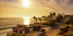 Sunset view of a scenic coastal neighborhood in California, illustrating the cost of moving out in the state.